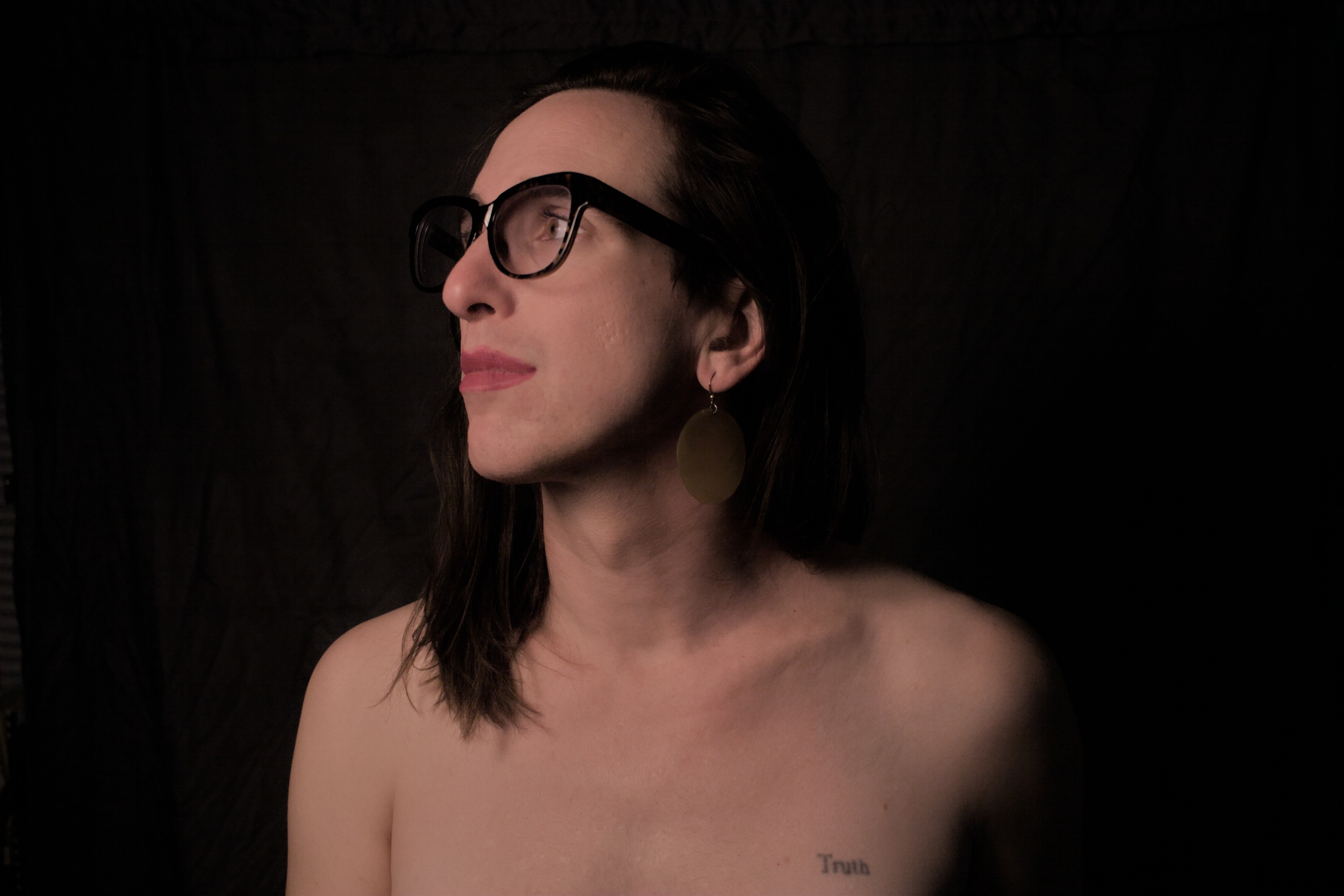 nervously naked, she looks away from the camera. she wants to be seen, and it seems she is sad that there is only a camera here to look.